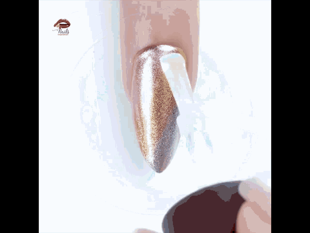 a close up of a person applying nail polish on a nail