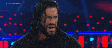 roman reigns is fighting a wrestler in a wrestling match on a television show .
