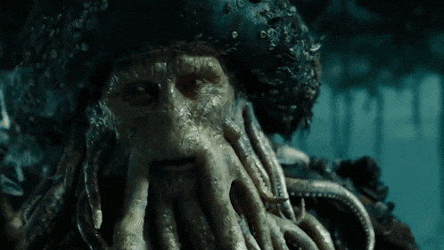 a close up of a squid 's face with tentacles