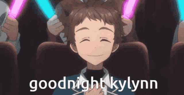 a boy with glowing sticks in his hair is sitting in a theater and says goodnight kylynn