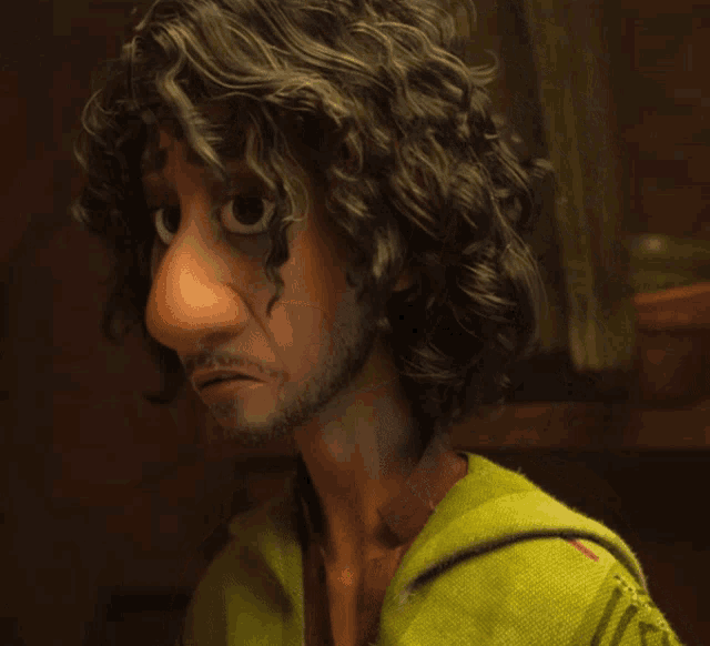 a man with curly hair and a beard is wearing a green shirt