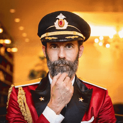a man with a beard is wearing a military uniform with gold stars