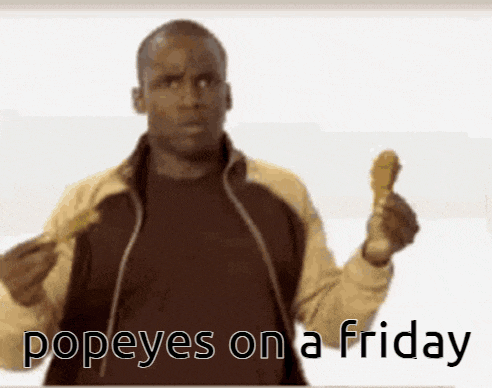 a man holding up a chicken wing with the words popeyes on a friday written below him