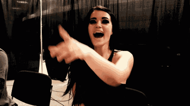 a woman giving a thumbs up with her mouth wide open