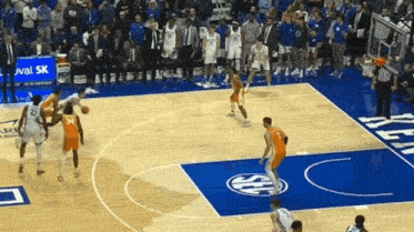 a basketball game is being played on a court with a sea logo on the floor