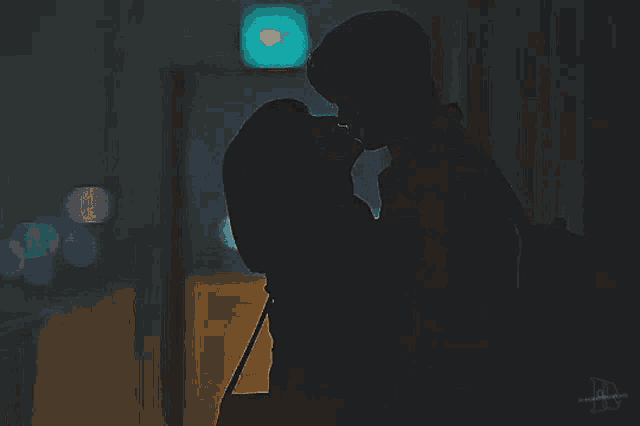 a silhouette of a man and woman kissing with the letters a and b on the bottom