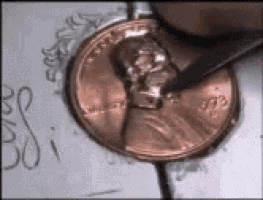 a penny is being scratched with a pencil