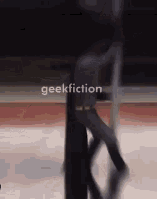 a blurry picture of a person standing next to a pole with the word geekfiction written on the bottom .
