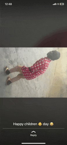 a phone screen displays a picture of a child and the words happy children day