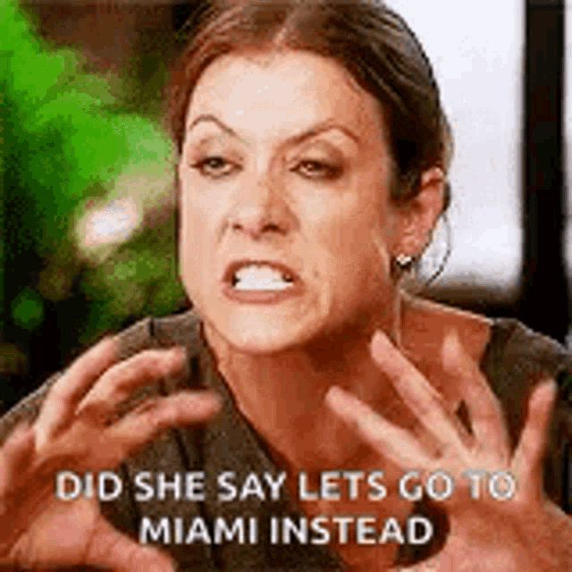 a woman is making a funny face and saying `` did she say lets go to miami instead '' with her hands in the air .
