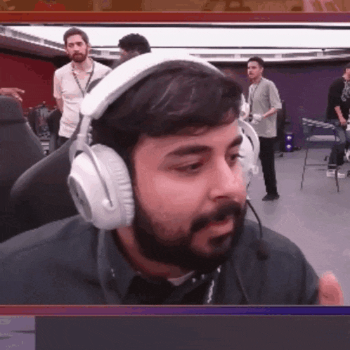 a man with a beard is wearing headphones with a microphone
