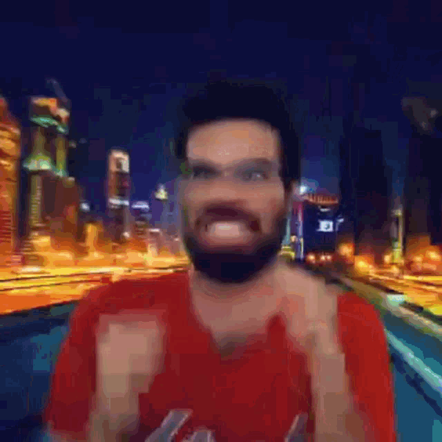 a man with a beard wearing glasses and a red shirt is making a funny face