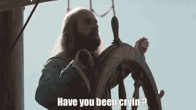 a man behind a steering wheel with the words have you been cryin ' below him
