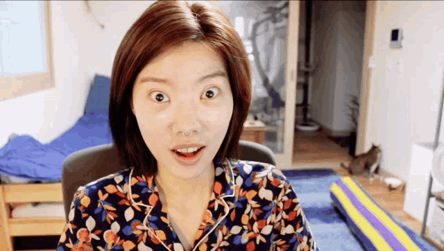 a woman with a nose ring looks surprised in a room