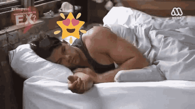 a man is sleeping in a bed with a sign that says ex on it