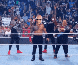 a group of wrestlers in a ring with one wearing a mask that says " one "