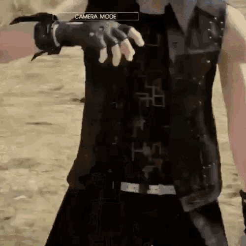 a person in a video game is wearing a black vest and gloves and the camera mode is visible