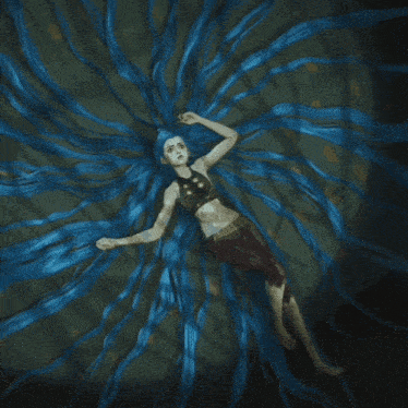a woman with long blue hair is laying down