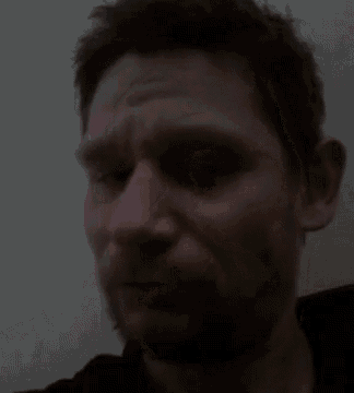 a man with a beard is looking at the camera