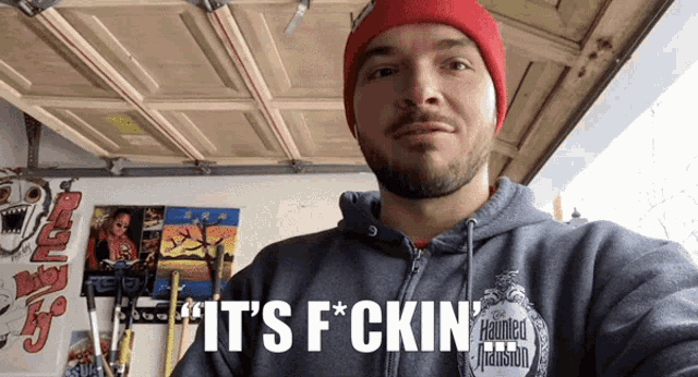 a man is wearing a haunted mansion hoodie
