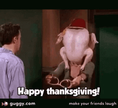 a man is standing next to a woman holding a turkey with a hat on its head .
