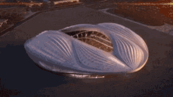 an aerial view of a soccer stadium with a yellow field