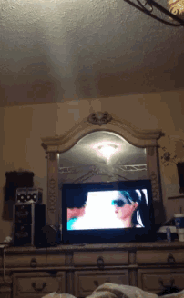 a bedroom with a dresser and a flat screen television