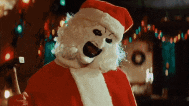 a man in a santa claus costume is holding a drink
