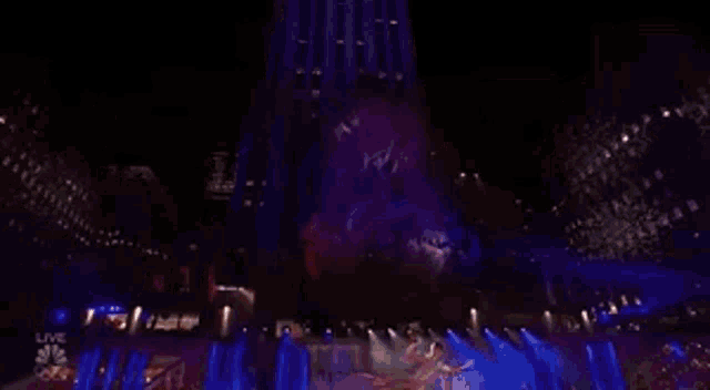 a large christmas tree is lit up at night