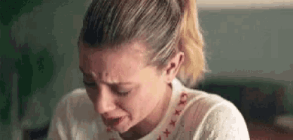 a close up of a woman crying with her eyes closed .