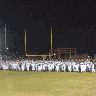 a group of football players are lined up on a field