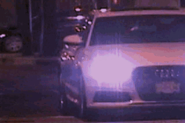 a car 's headlights are lit up in the dark