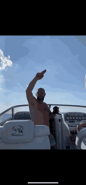 a shirtless man is sitting on a boat with the word freedom on the back