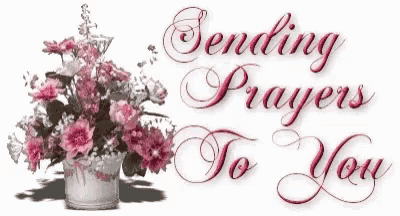 a sign that says sending prayers to you with flowers in the background