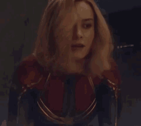 a close up of a woman in a captain marvel costume .