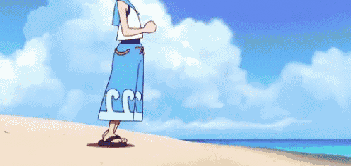 a boy and a seal are standing on a beach .