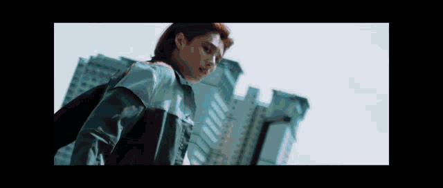 a woman with red hair is standing in front of a building .