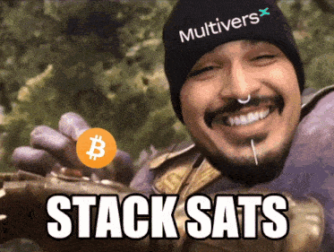 a man wearing a beanie that says multivers stack sats