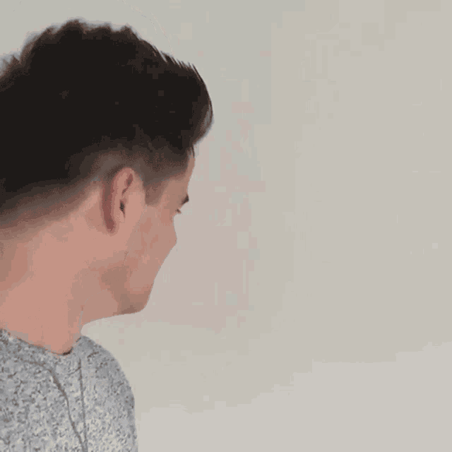 a close up of a young man 's face against a white background