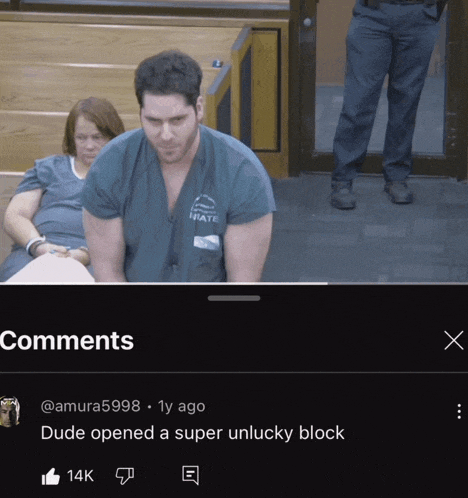 a man in a state scrub is sitting in a courtroom with a woman behind him