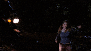 a woman with a blue light behind her