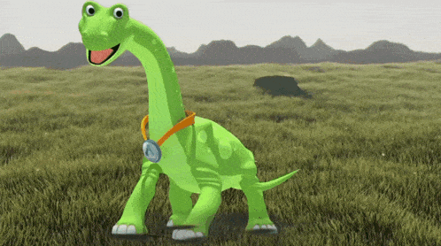 a green dinosaur with a medal around its neck stands in a grassy field