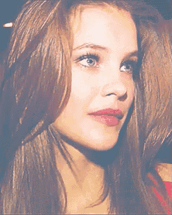 a close up of a woman 's face with long hair