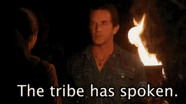 a woman holding a torch with the words the tribe has spoken above her