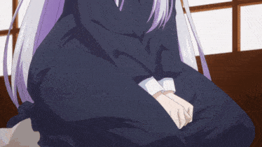 a girl with purple hair is sitting down with her hands folded