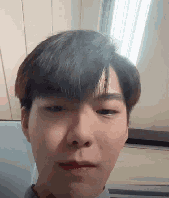 a close up of a person 's face with a light behind him