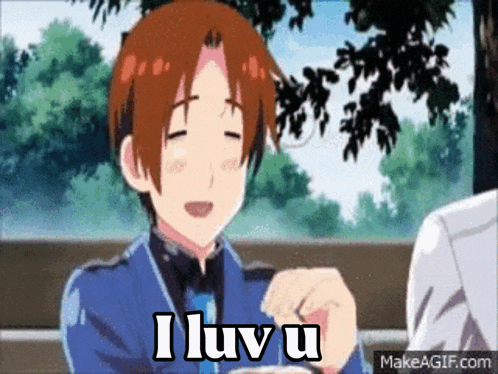 a man in a blue suit says i luv u while sitting at a table