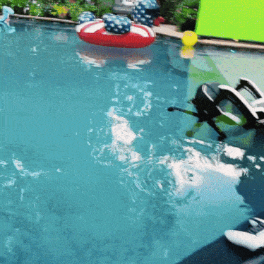 a swimming pool with a red white and blue life preserver