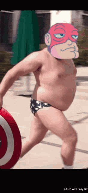 a man in a bathing suit is holding a red and white circle
