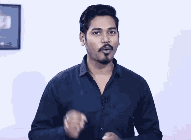 a man in a black shirt with a microphone on his collar